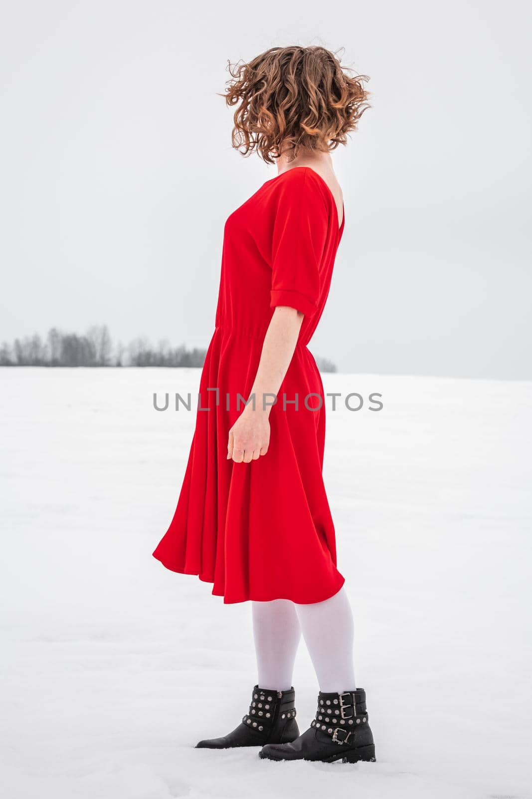 Beautiful woman in a red dress by RuslanKphoto