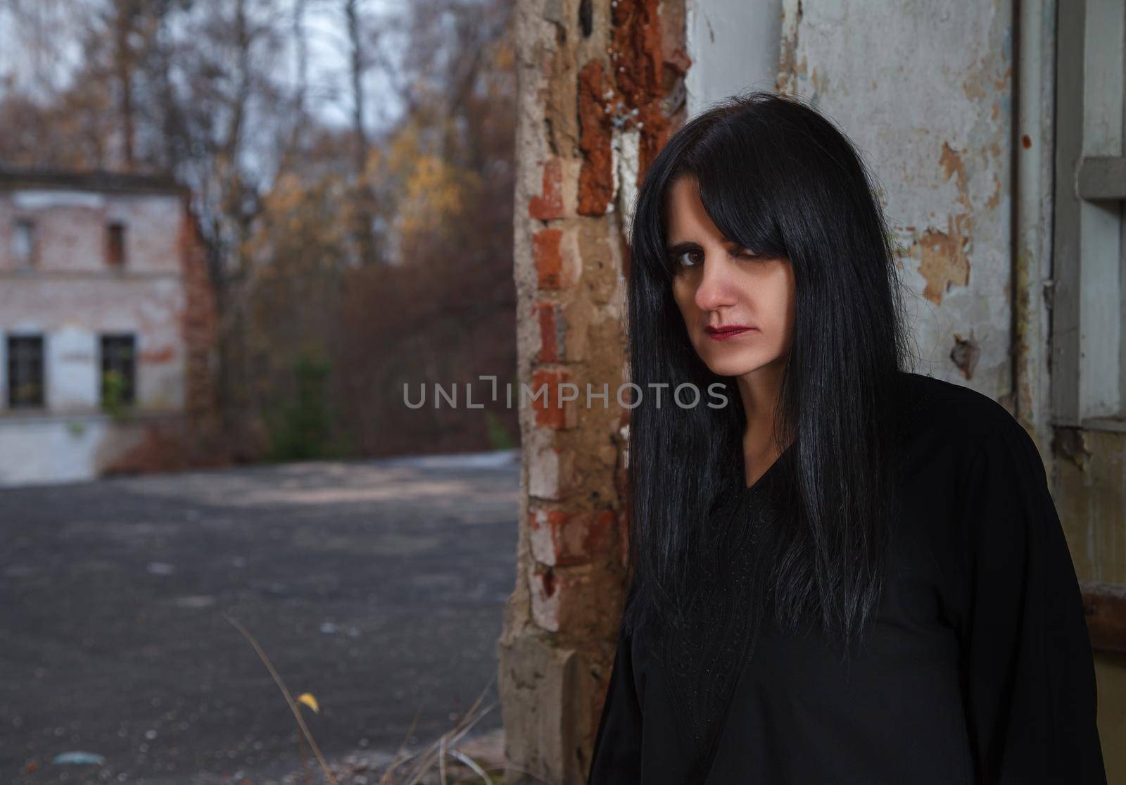 portrait of young goth woman in an abandoned building by raddnatt