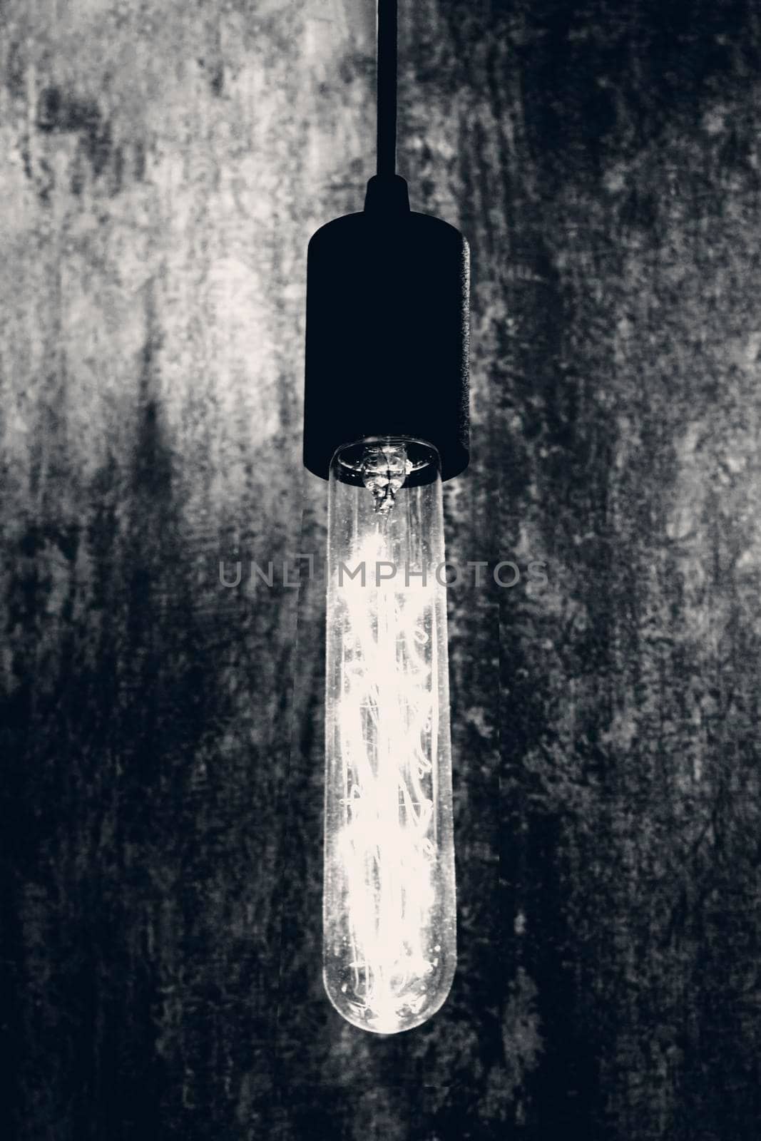 Light bulb in retro style. Front view, indoors vertical shot. by Essffes