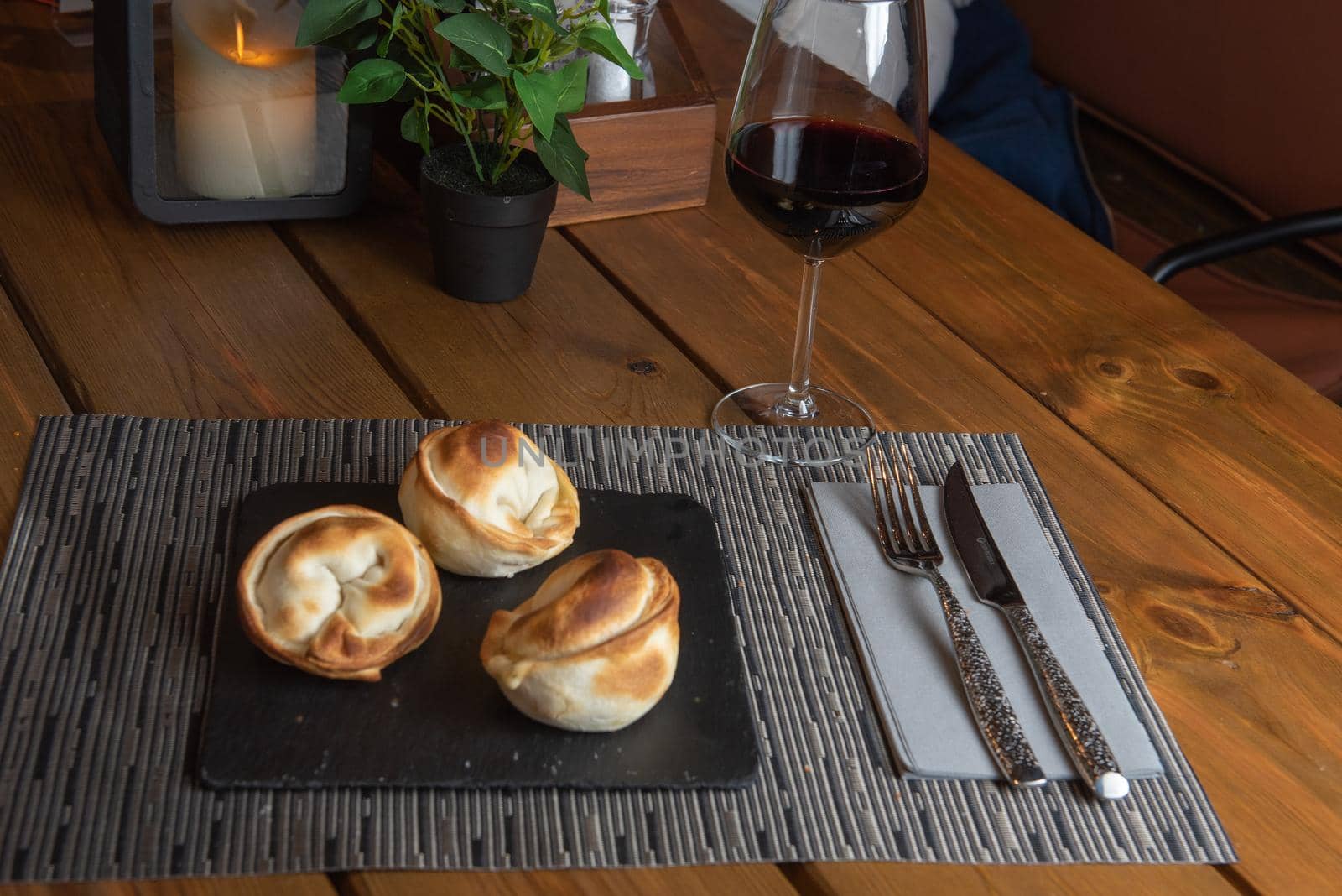 Homemade empanadas with a black stone plate.
