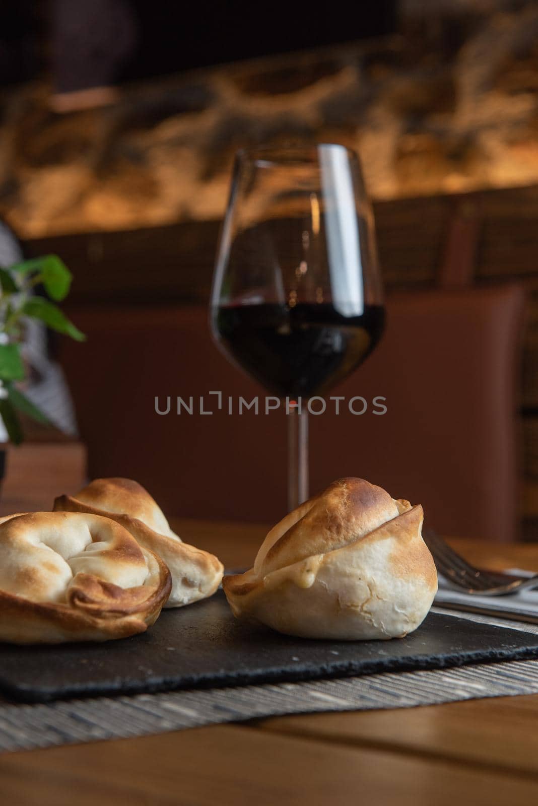 Homemade empanadas with a black stone plate.