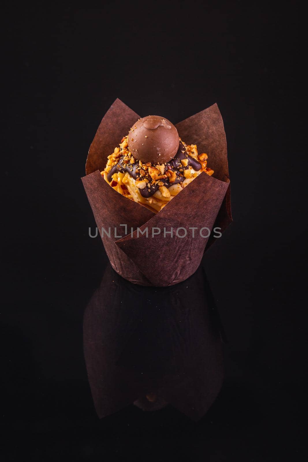 Peanut Butter Cupcake On A Black Background With Reflection.