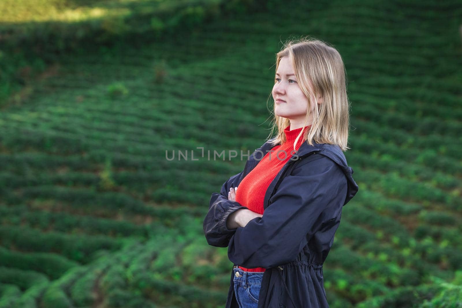 Maiden in a red blouse posing at the tea plantation in Haremtepe Ceceva village, Rize, Turkey.