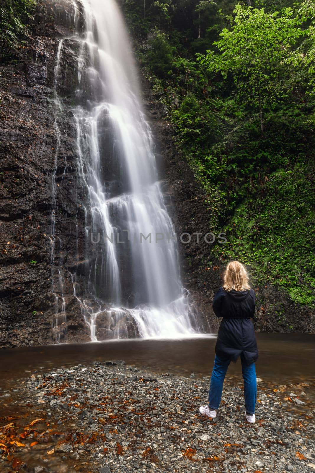 Woman posing at the Tar waterfall near Rize, Turkey.