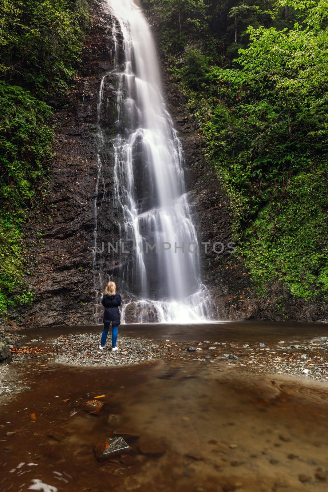 Woman posing at the Tar waterfall near Rize, Turkey.