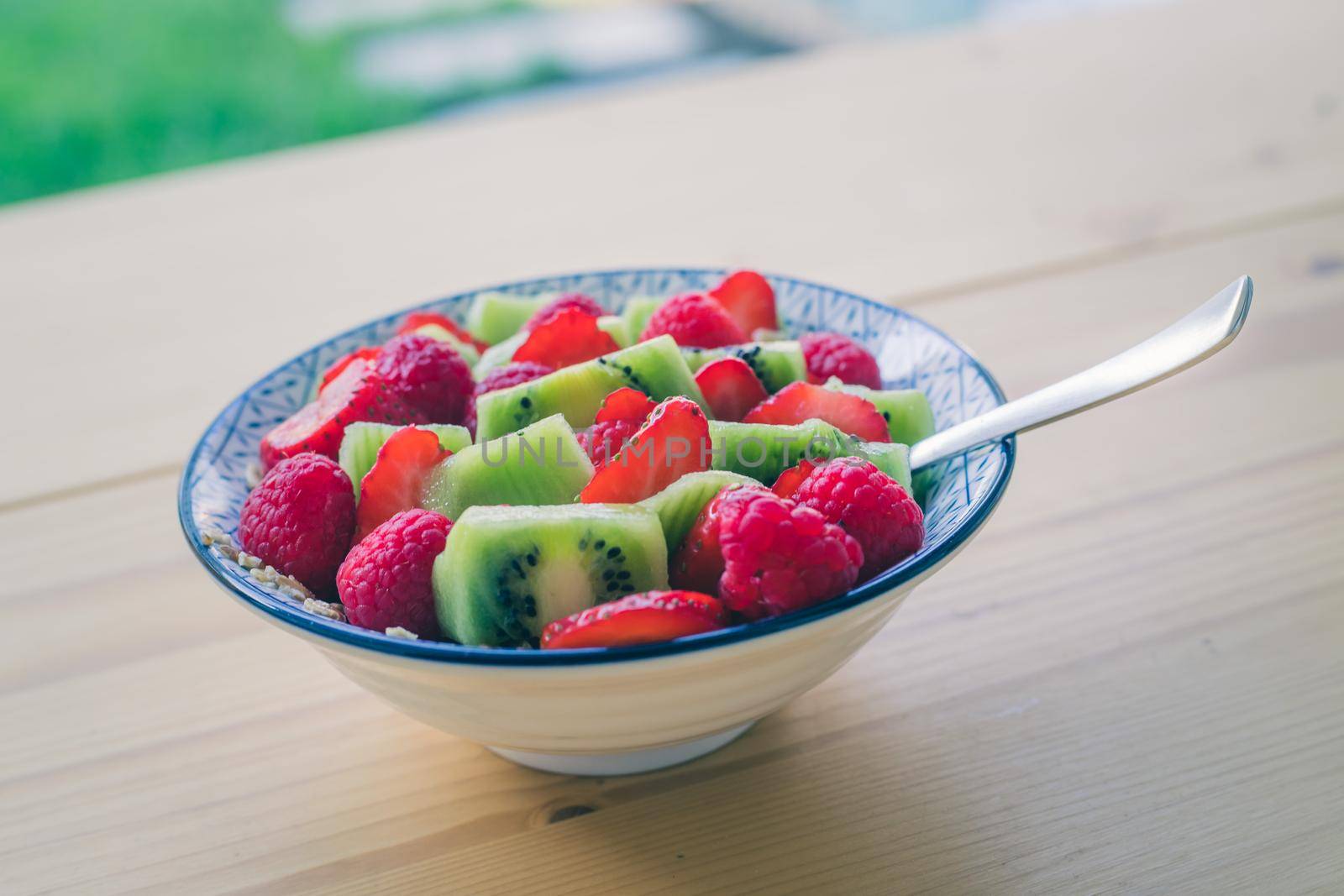 Breakfast fruit bowl with strawberries and kiwis, close up. Healthy lifestyle for vegetarians. by Daxenbichler