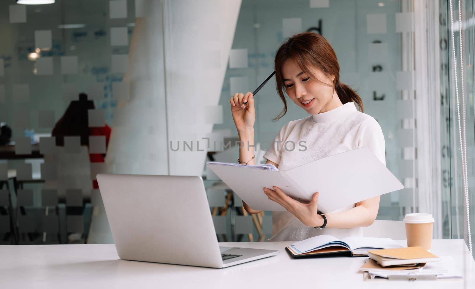 Portrait of asian female working with laptop computer for online business or education concept