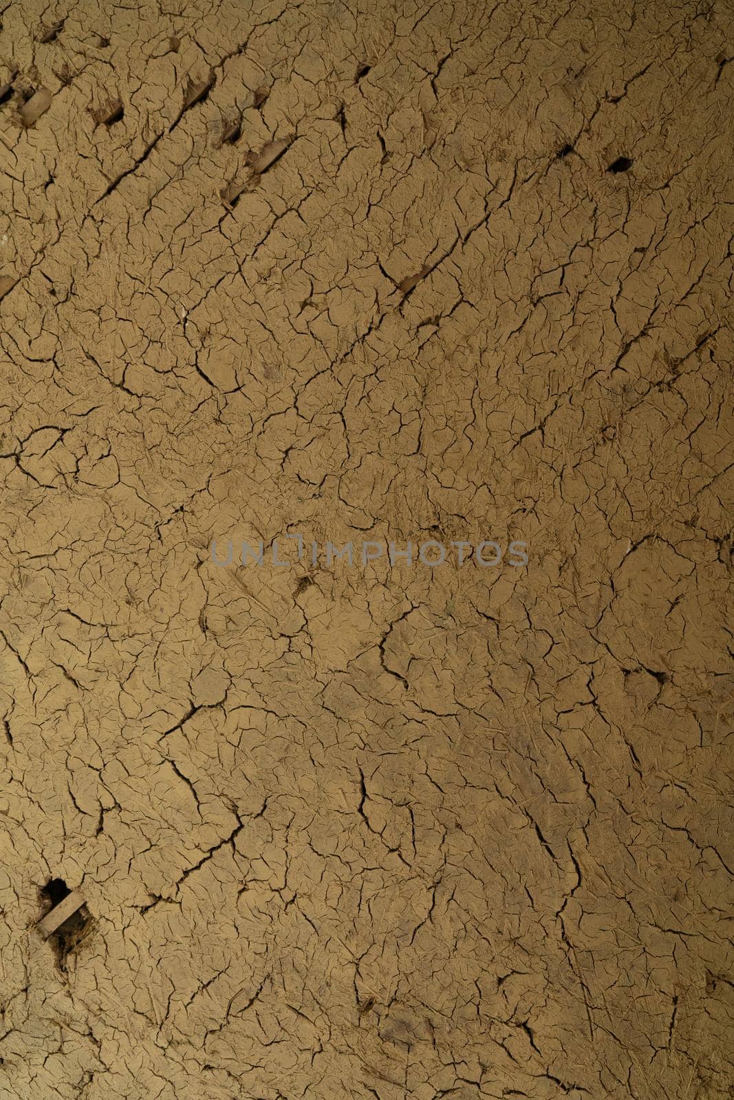 Cracked dry clay wall texture or background