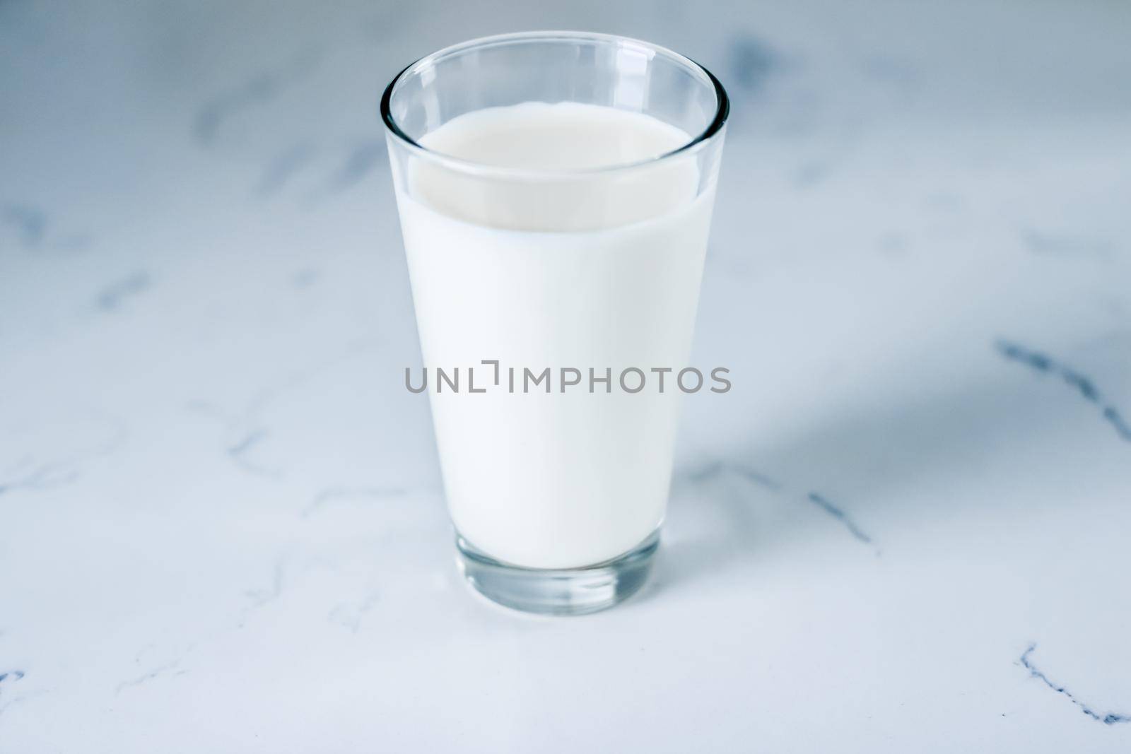 Dairy, healthy nutrition and breakfast concept - World Milk Day, full glass on marble table