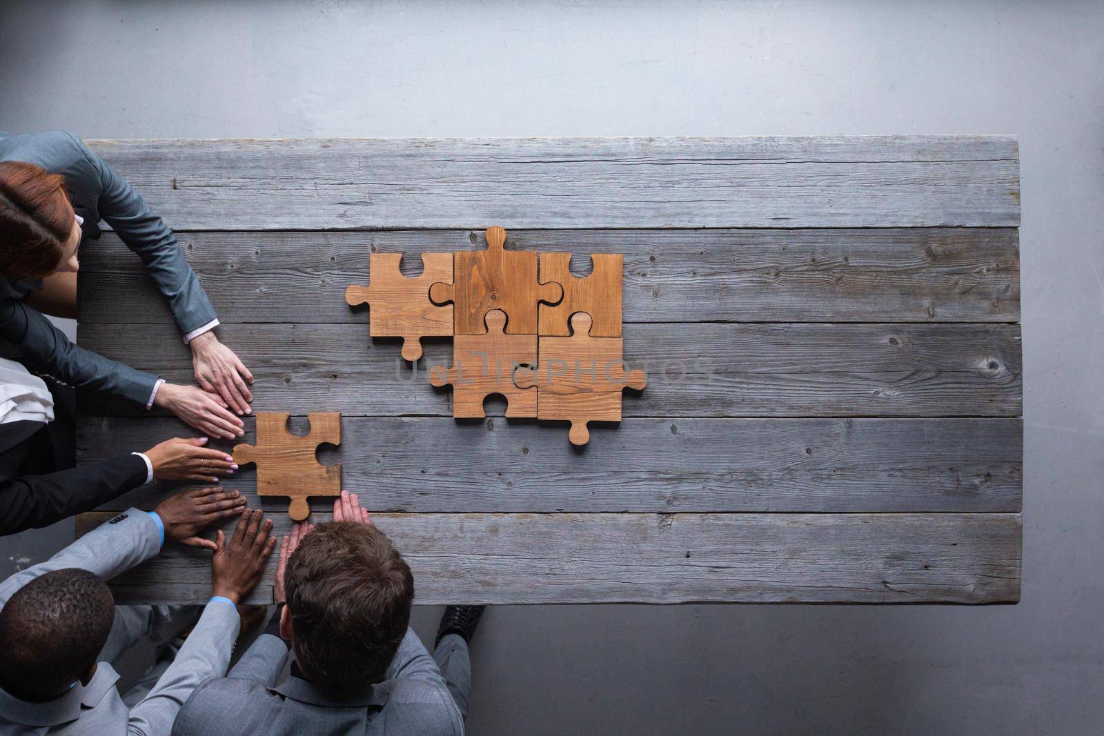 Business teamwork with puzzle by ALotOfPeople