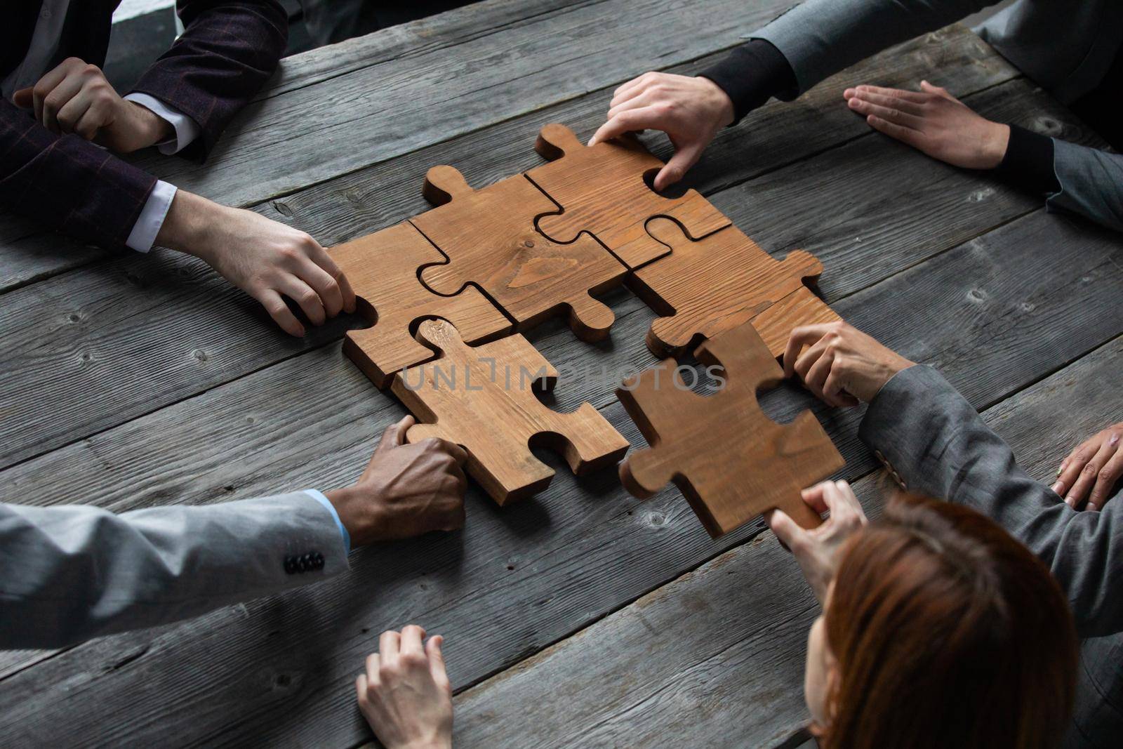 Business teamwork with puzzle by ALotOfPeople