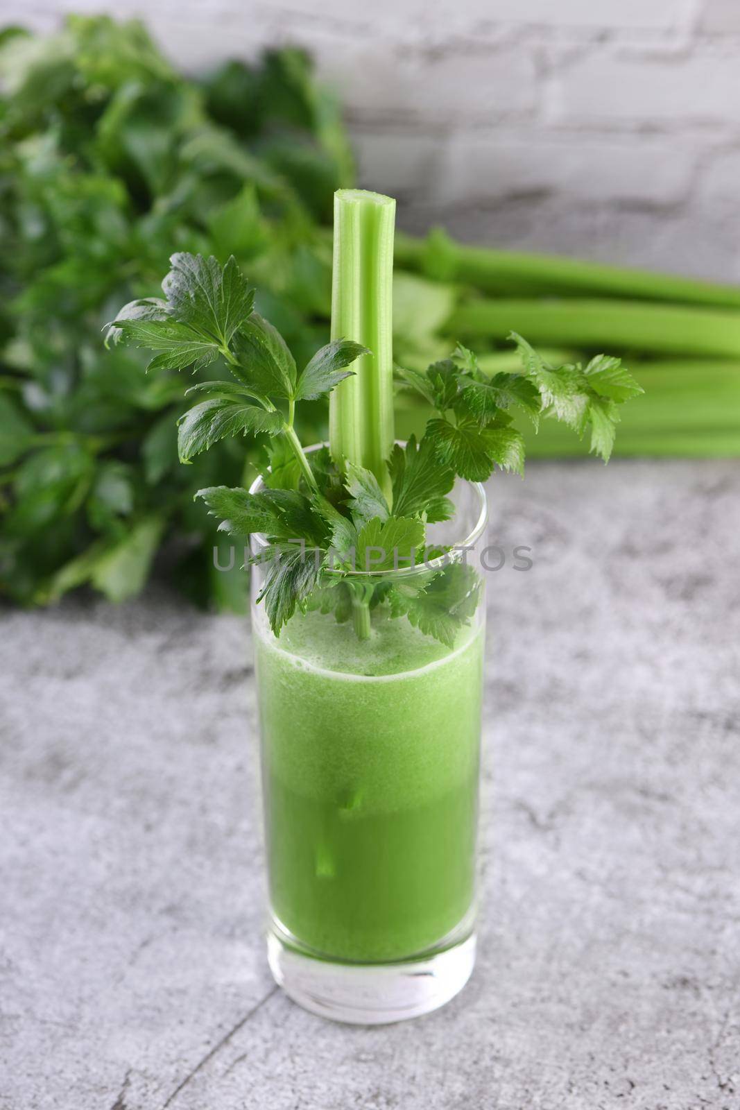 A glass of freshly made celery smoothie. A detox drink for those who care about health.