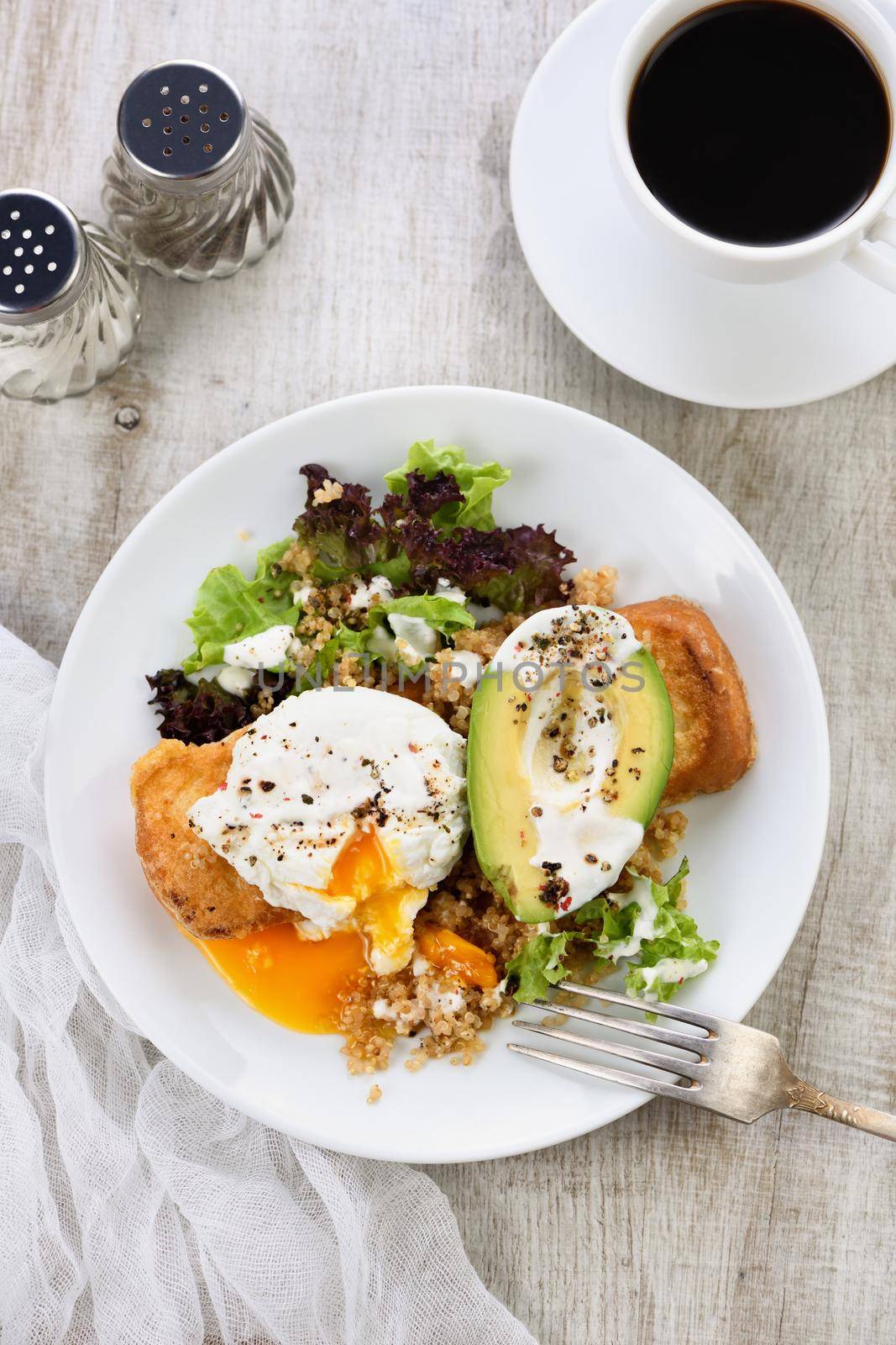A healthy and balanced breakfast plate.
Benedict's egg spreads on a toasted toast with half an avocado, quinoa and lettuce, seasoned   spices and yogurt dressing. Enjoy the most important meal of the day
