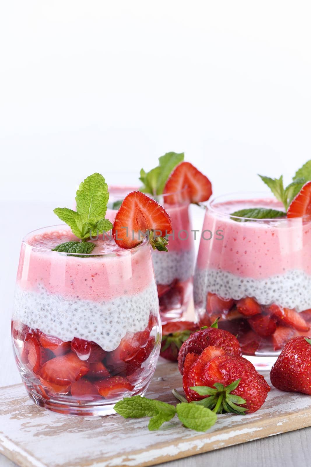 Strawberry dessert with milk vanilla chia and fresh strawberry pieces