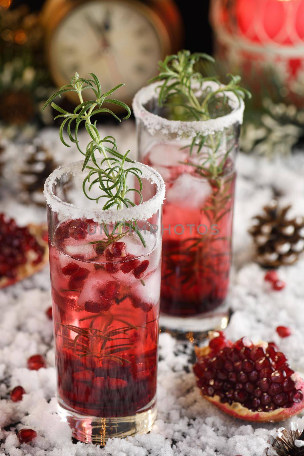 Glass with pomegranate Margarita with candied cranberries, rosemary. Perfect cocktail for a Christmas party