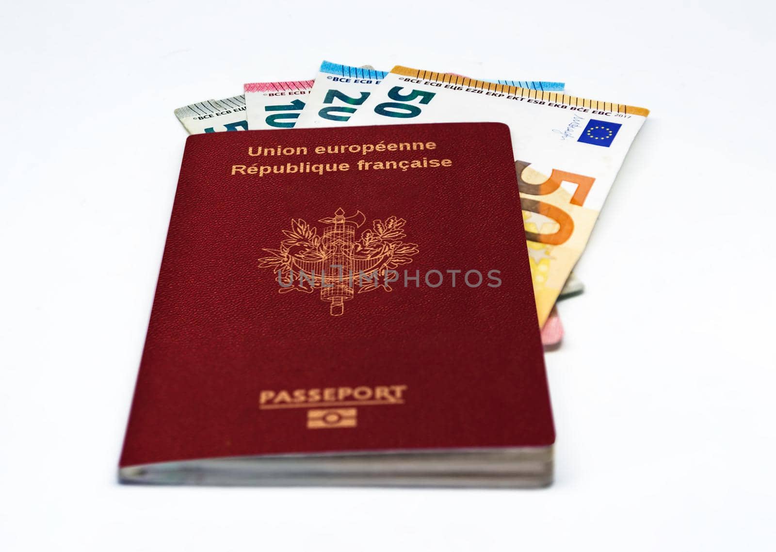 French travel passport with some euro banknotes isolated on a white background. European Union and single currency. Travel and cash