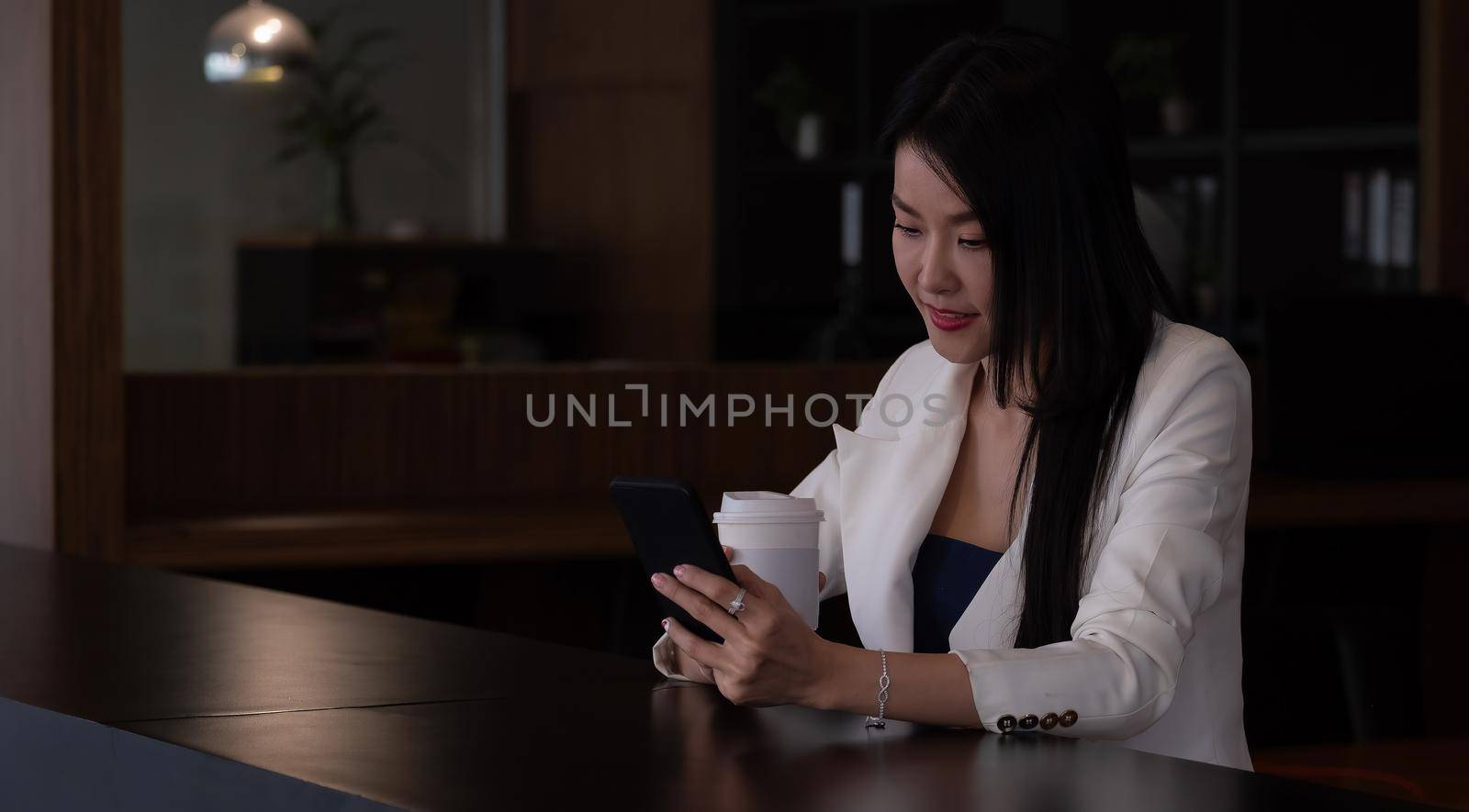 Business woman using smart phone for video call.