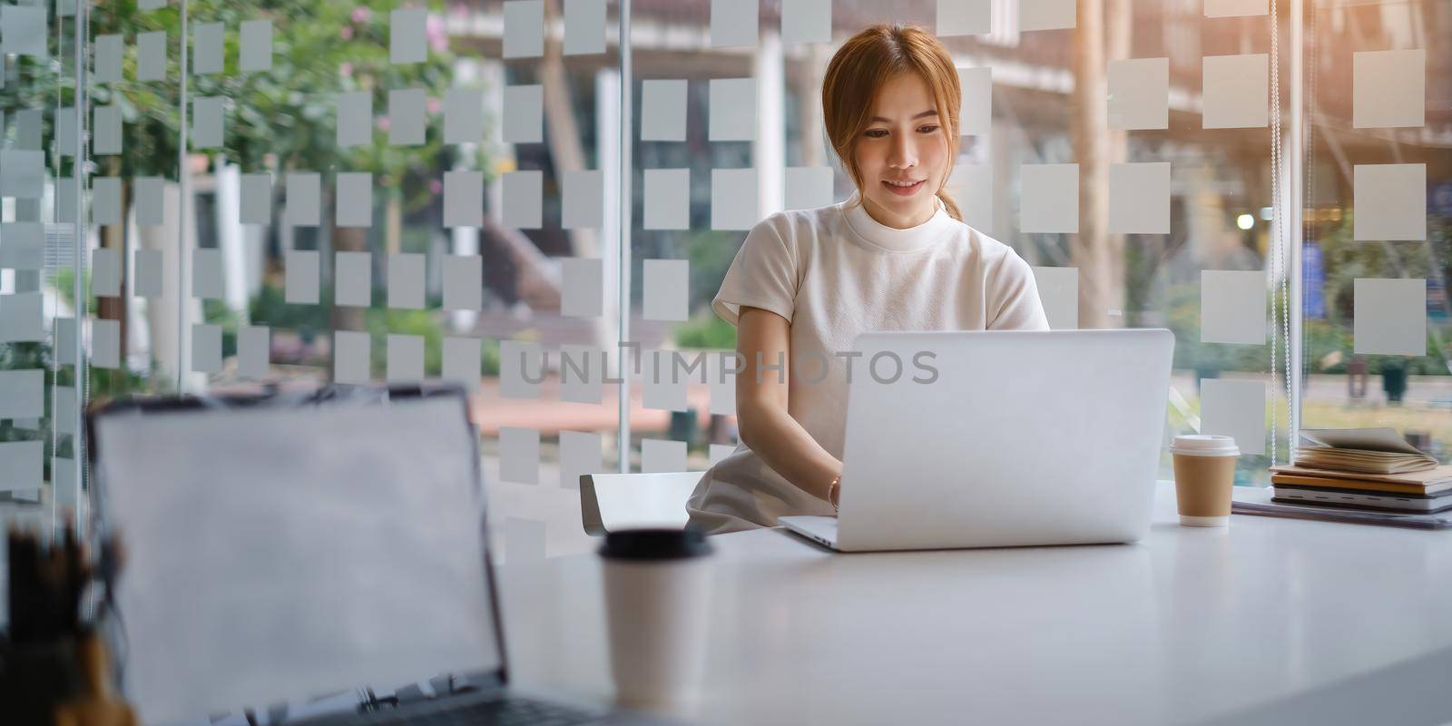 Asian Business woman checking email at morning in office. finance, fund, investment concept. by itchaznong