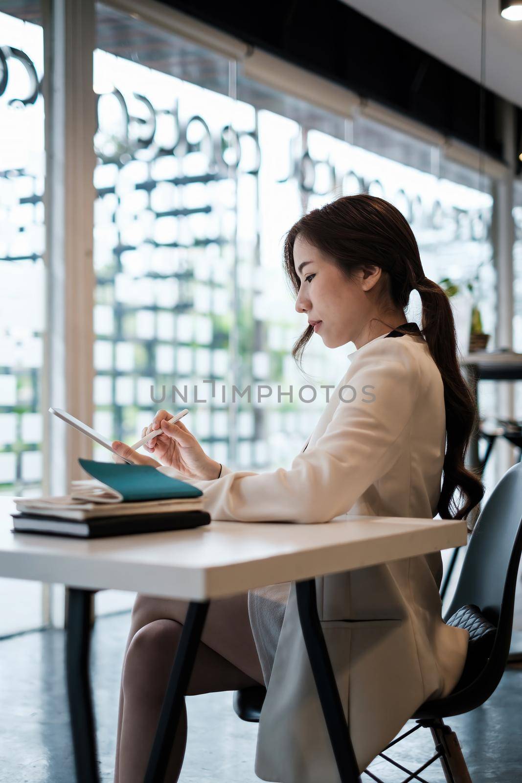 Asian Business woman checking email at morning in office. finance, fund, investment concept. by itchaznong