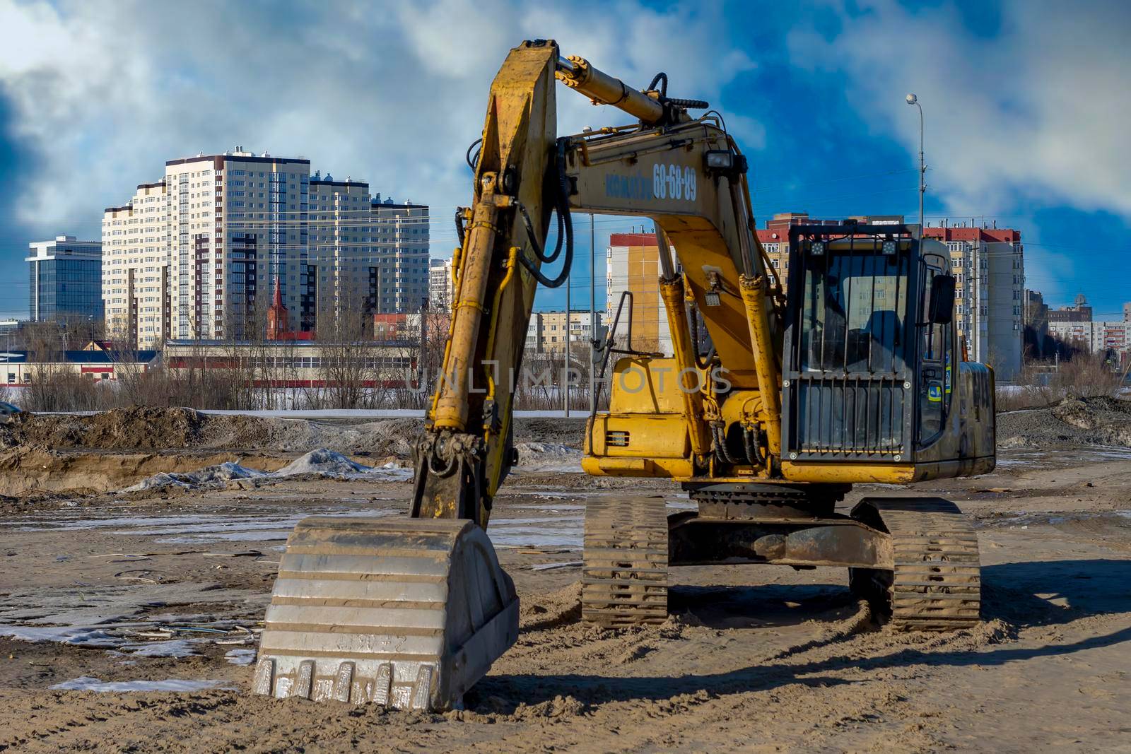 Yellow excavator or Bulldozers in town. Surgut, Russia - 20 April, 2021. by Essffes