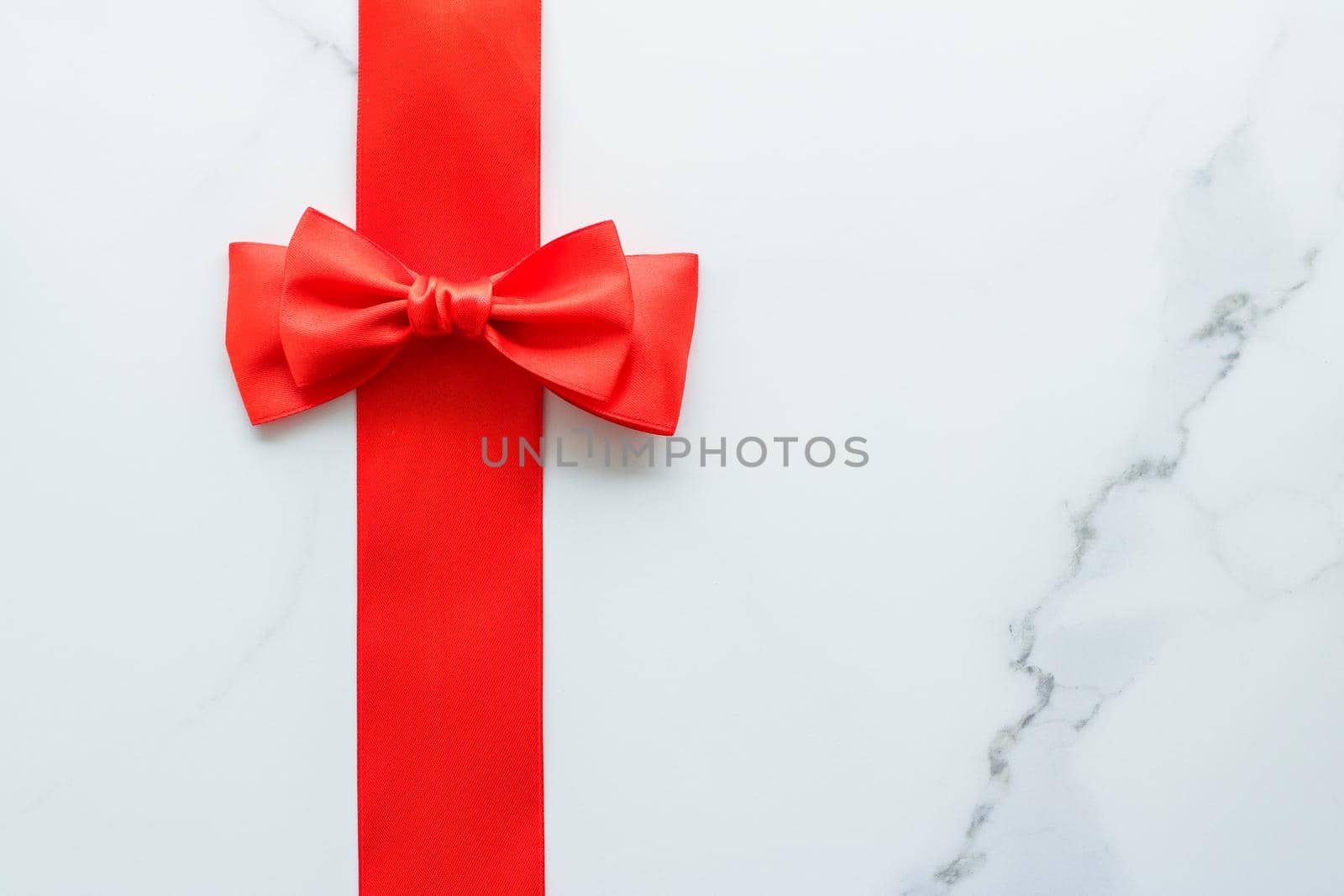 Red silk ribbon on marble, top view by Anneleven