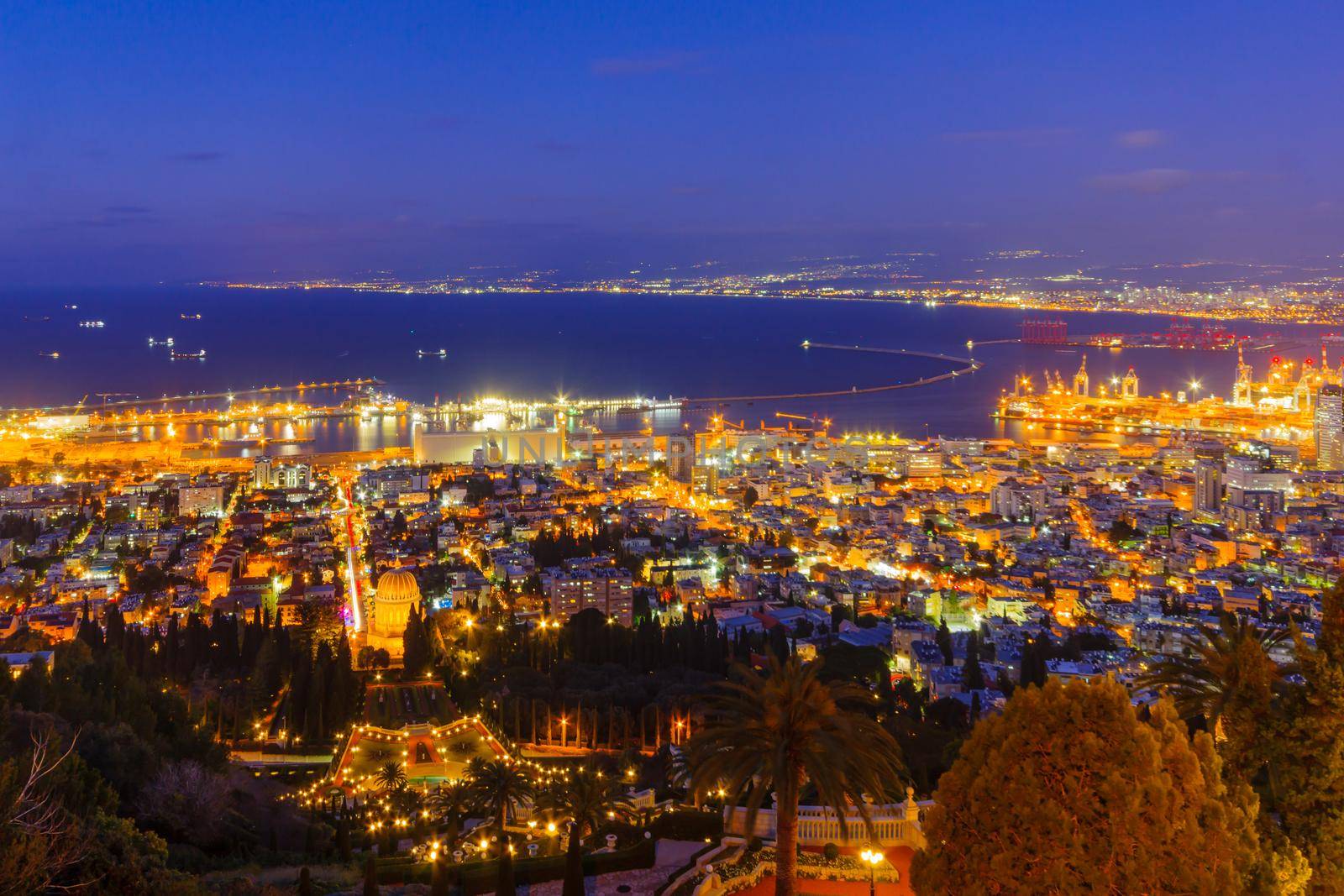 Night view of the Bahai Shrine and gardens, with the downtown and the port, in Haifa, Northern Israel