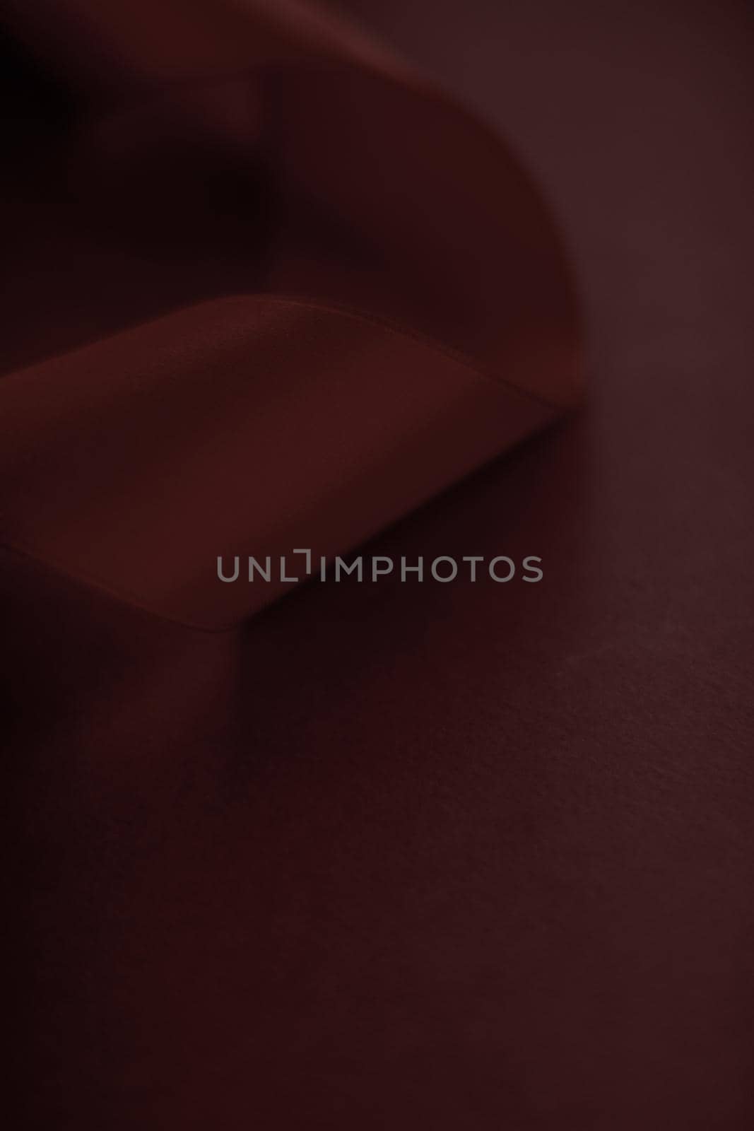 Branding, holidays and luxe brands concept - Abstract silk ribbon on chocolate background, exclusive luxury brand design for holiday sale product promotion and glamour art invitation card backdrop