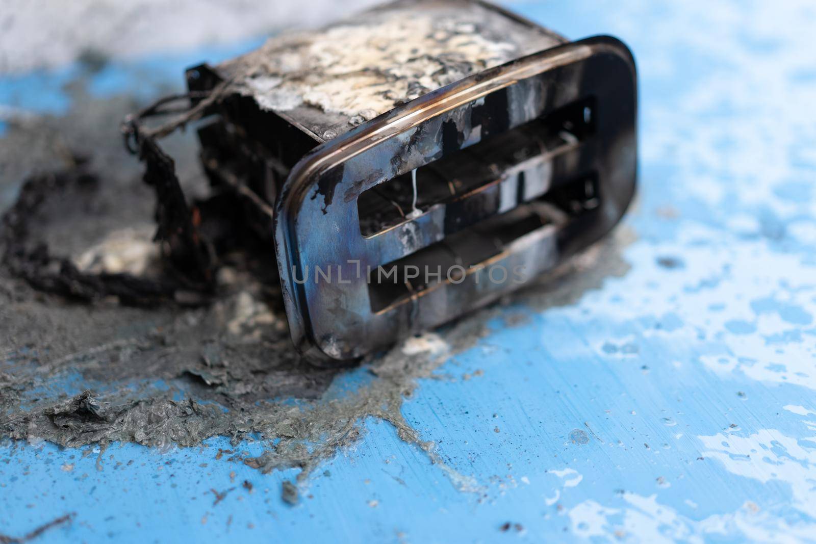 Toaster after fire. Household electrical appliance fire hazard. Overload. Short circuit. Carelessness. Safety in home. Danger home inflammation Insurance concept