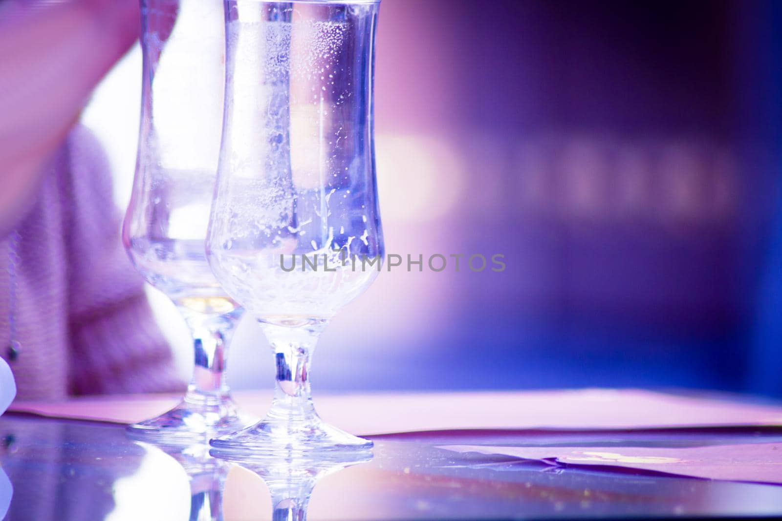 Hands holding a cigarette with empty beer glasses by GemaIbarra
