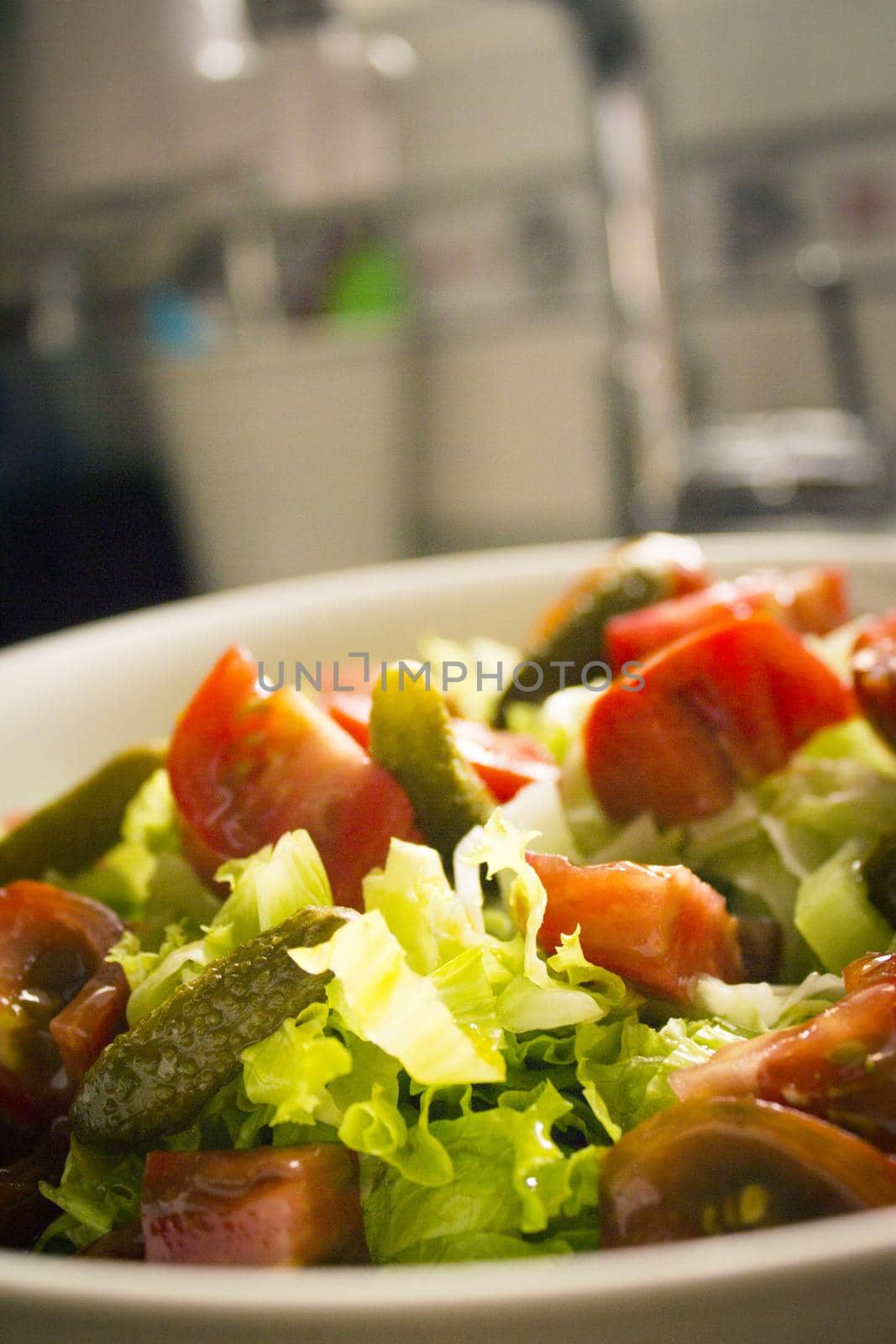 Lettuce salad with tomato and pickles. Raw food