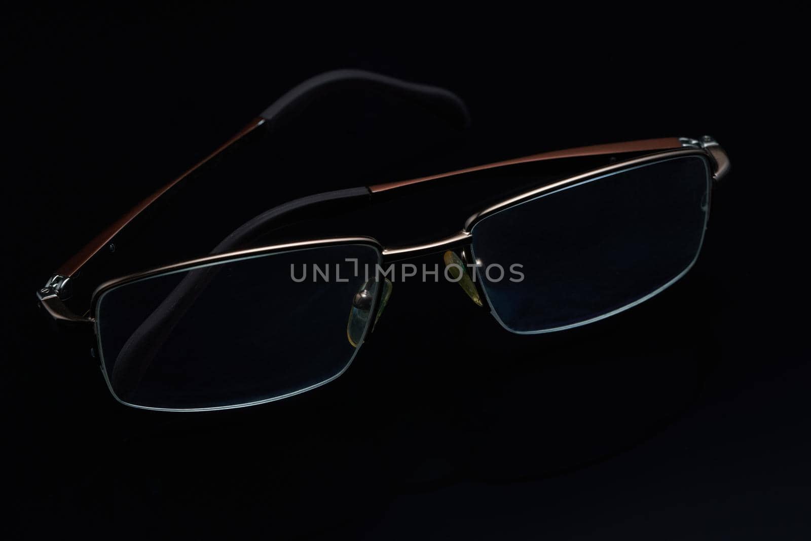 Glasses in fashionable frames on a black background. Close up