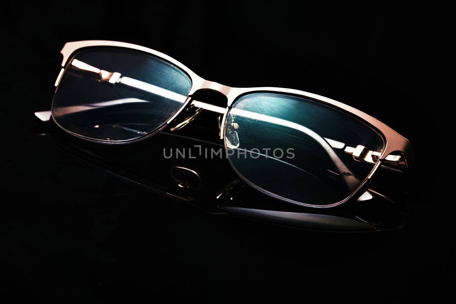 Glasses in fashionable frames on a black background. Close up