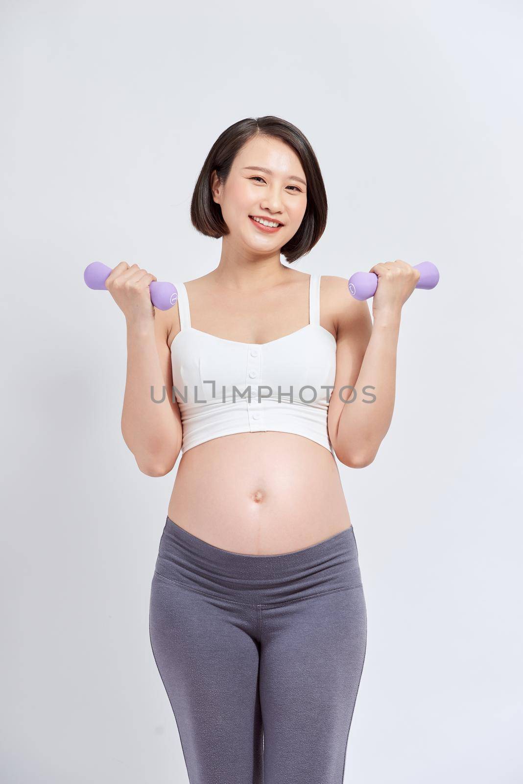 Pregnant woman is doing exercises at the gym