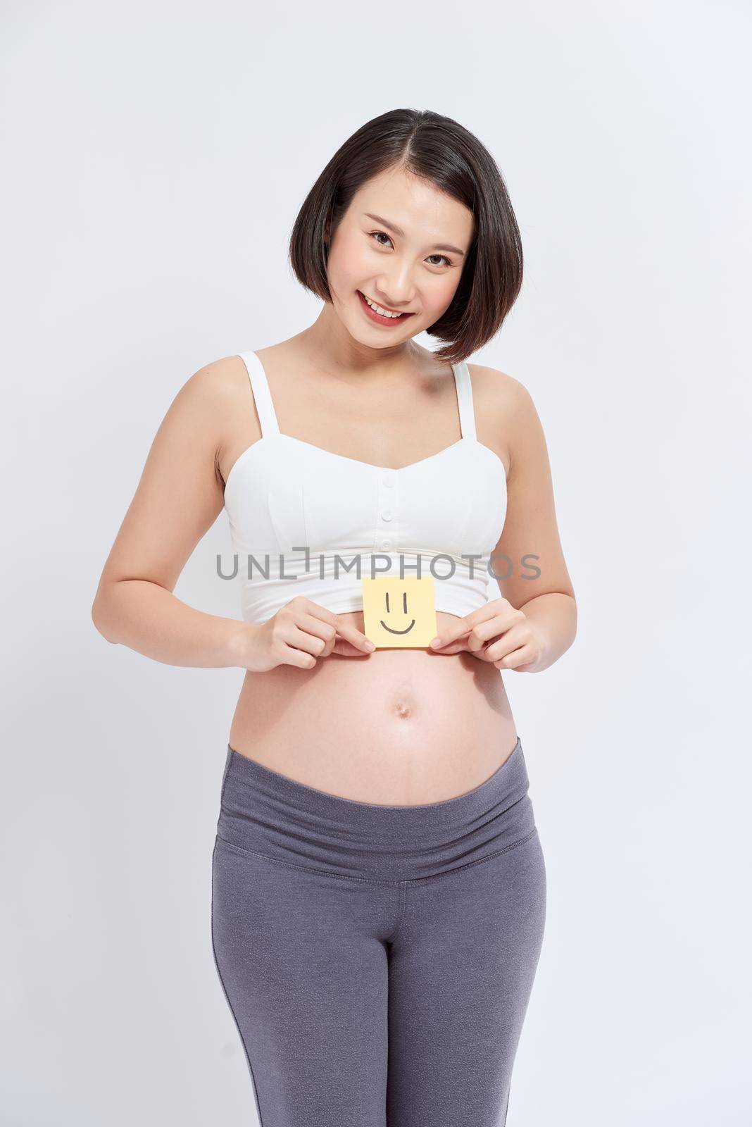 Pregnant woman with paper stickers on tummy by makidotvn