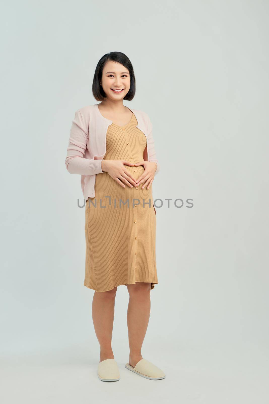 Pregnant woman on light background by makidotvn