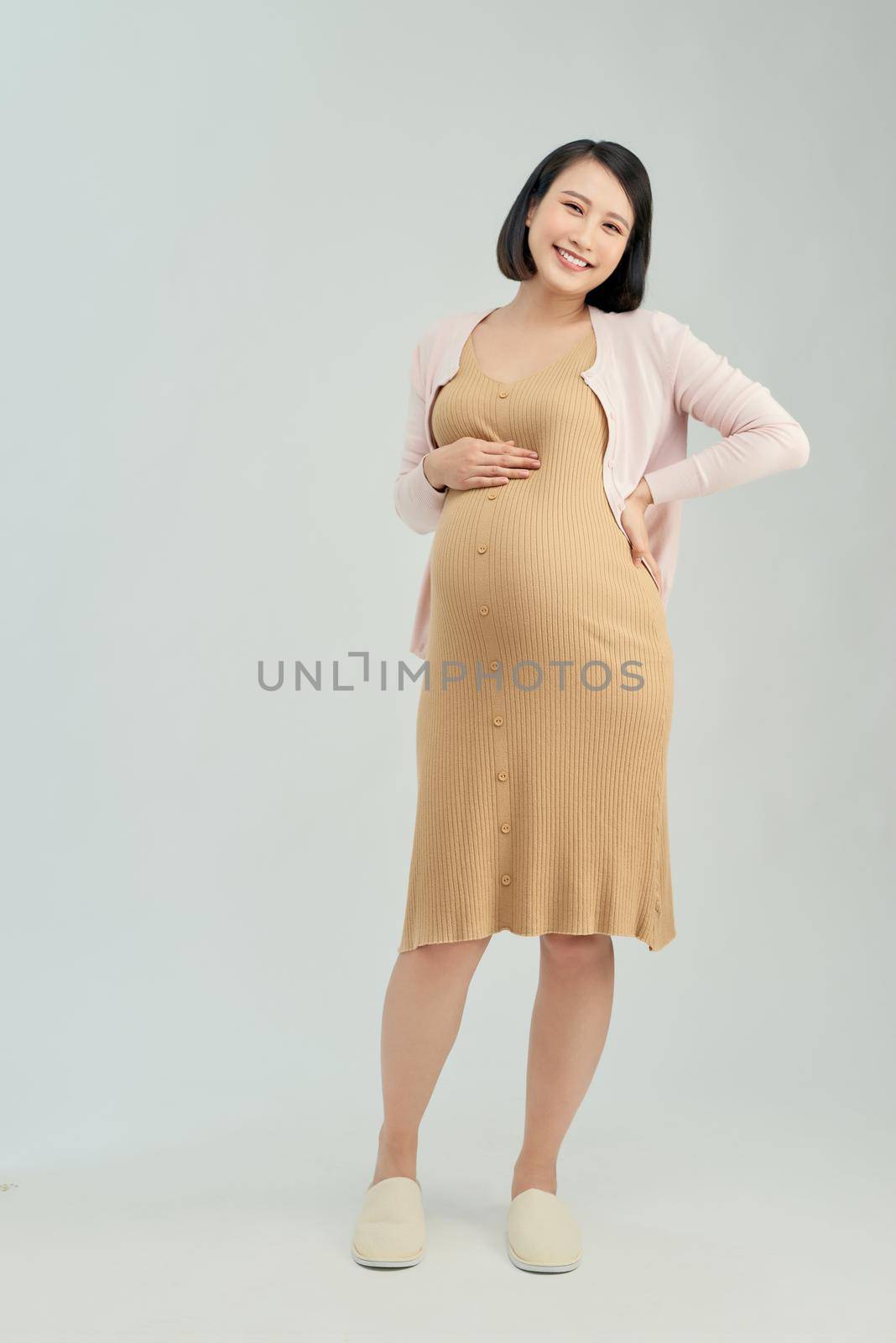 Pregnant woman on light background by makidotvn