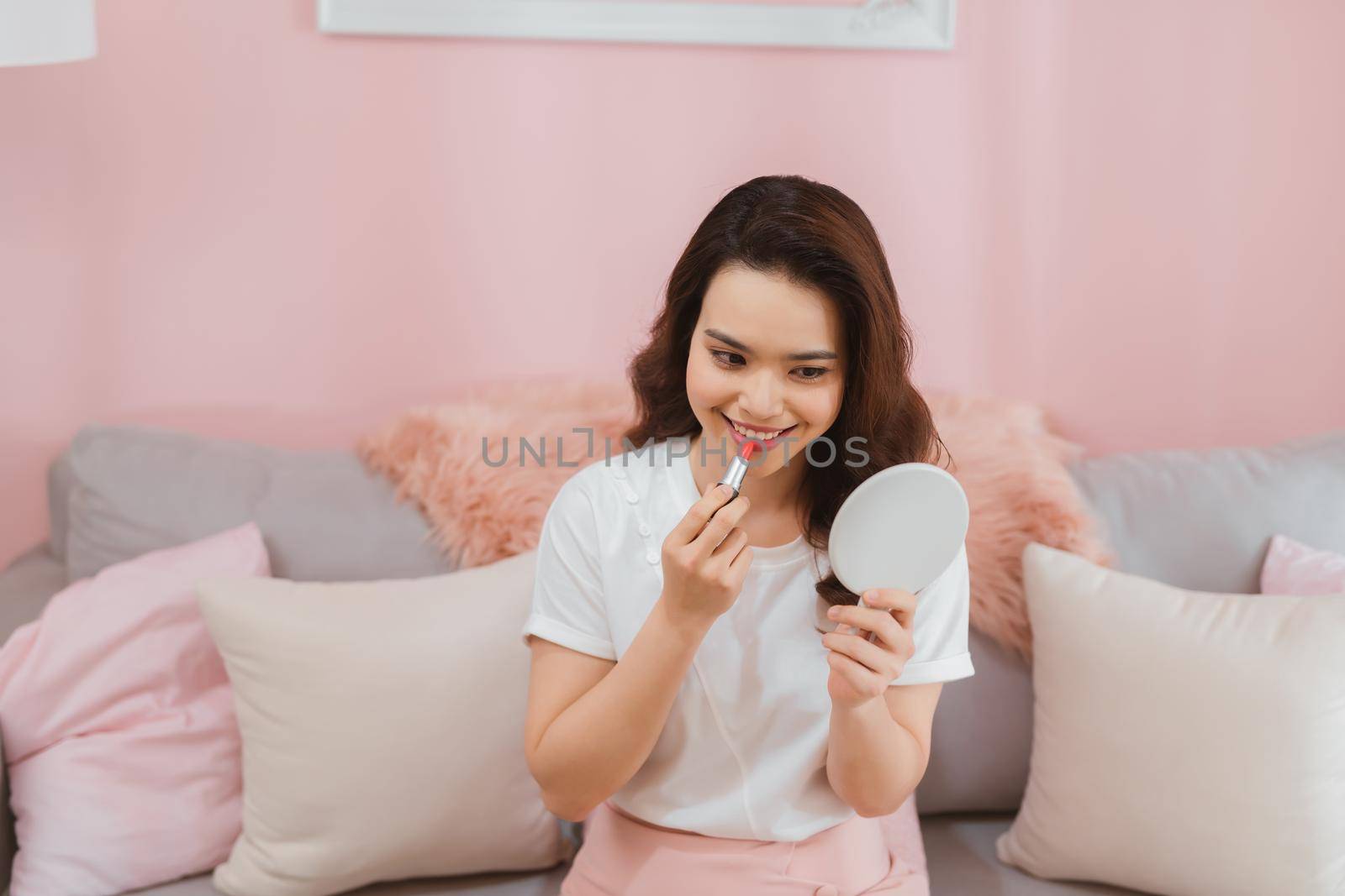 Portrait of young asian woman recording video make up lipstick cosmetic at home. Online influencer girl social media marketing live steaming concept by makidotvn