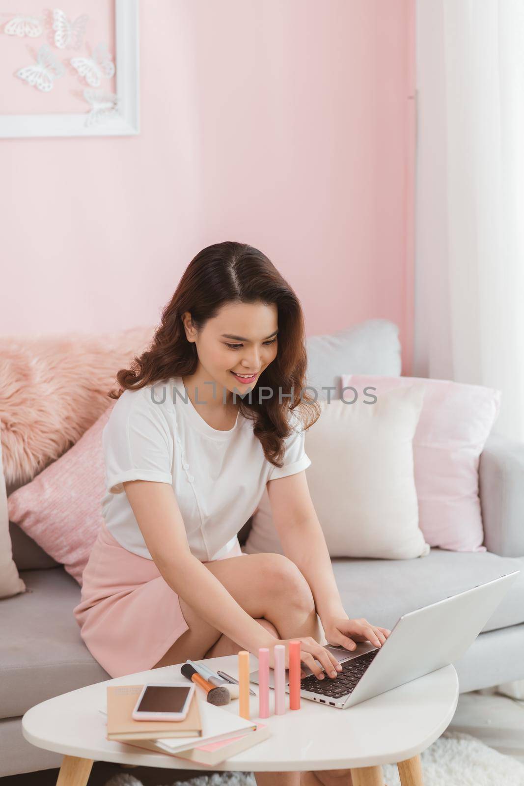 elegant asian lady freelance worker typing on laptop computer replying message online shop customer service internet by makidotvn