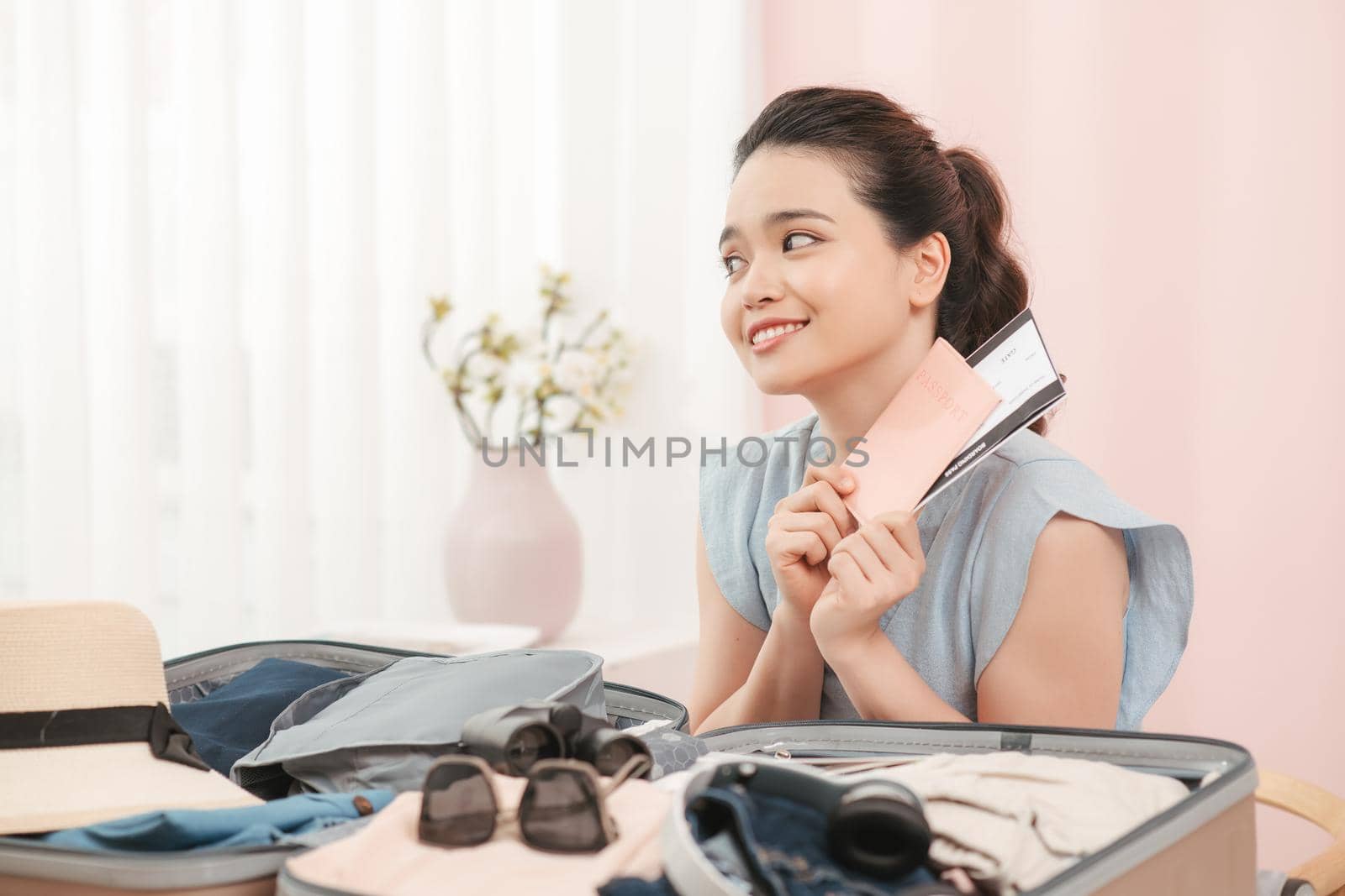 Beautiful Asian business woman smiling holding passport and ticket with yellow suitcase to prepare traveling for travel tourist on holiday weekend. 