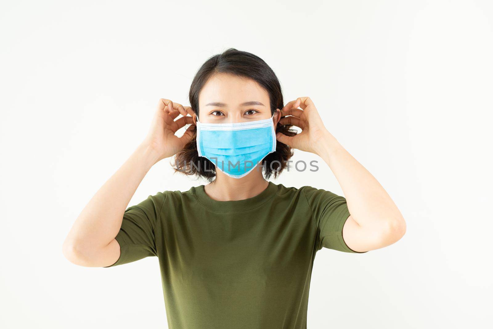 Asian woman wearing facial mask for protection from air pollution or virus epidemic on white background by makidotvn