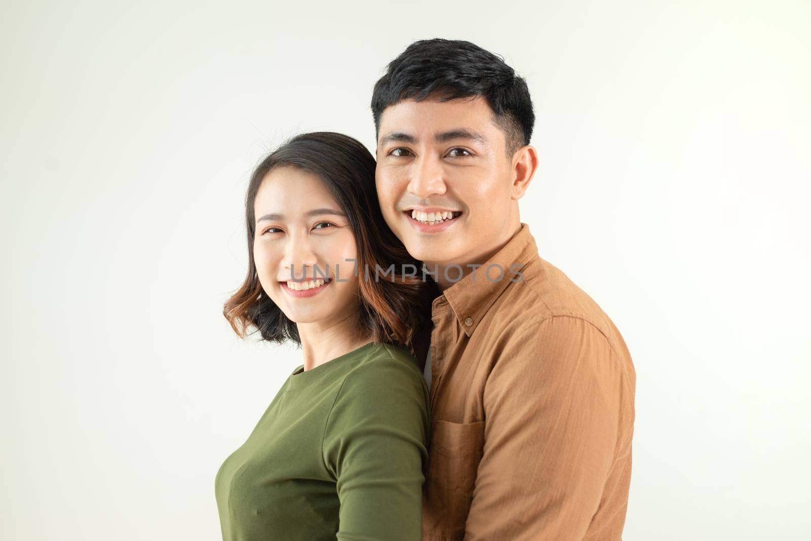 Portrait of young couple smiling on white background by makidotvn