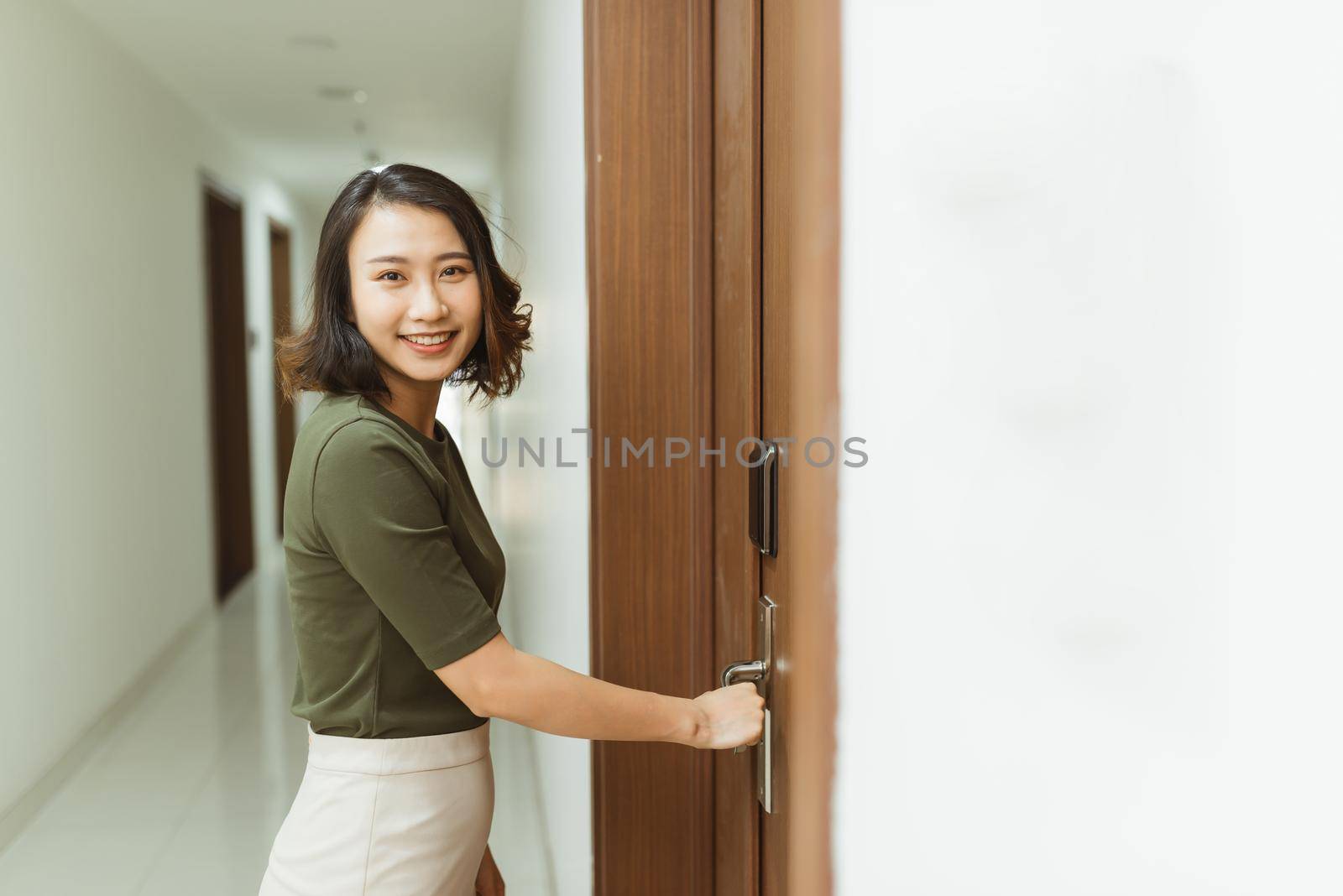 Woman hand holding modern door handles electronic lock open the door of apartment