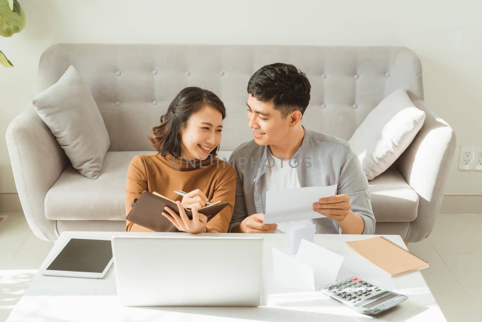 Young Asian man and woman stress with her business online shopping at office. by makidotvn