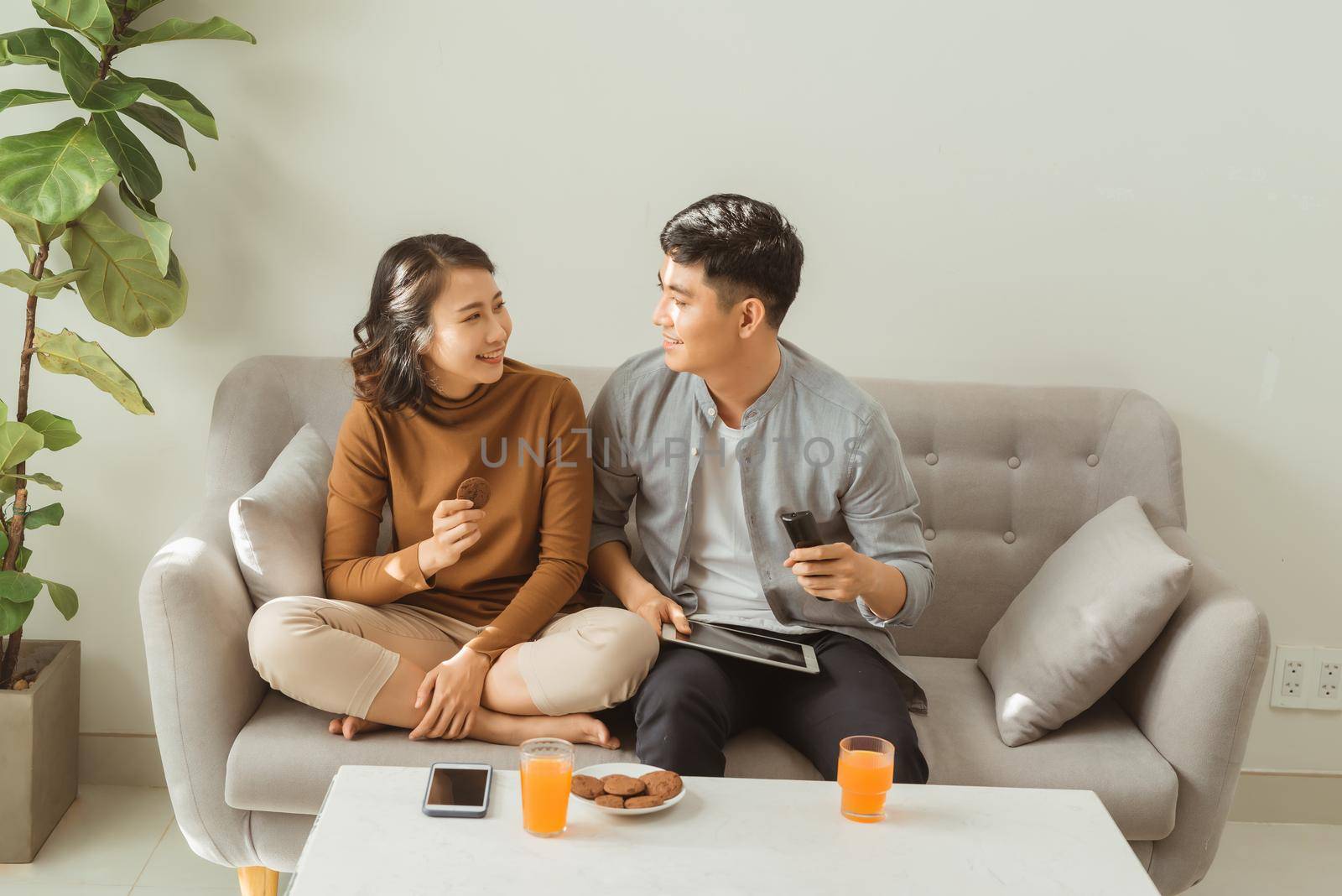 Enjoying their free time at home, watching tv.