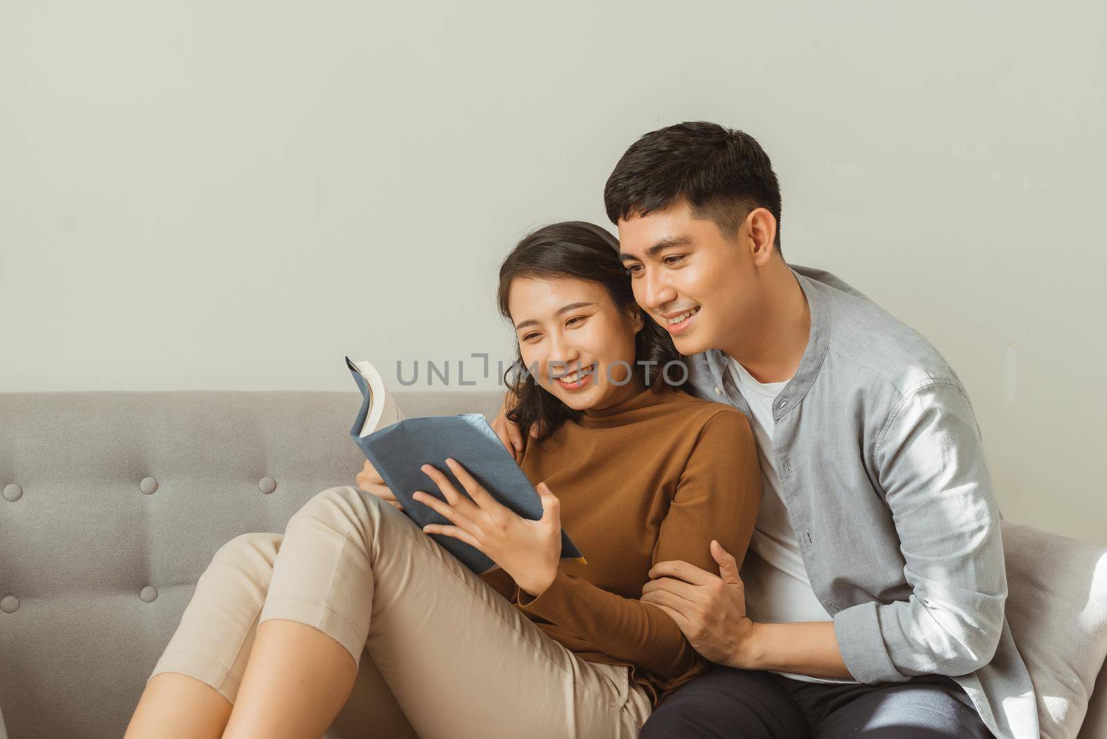 smiling romantic couple riding from the same book