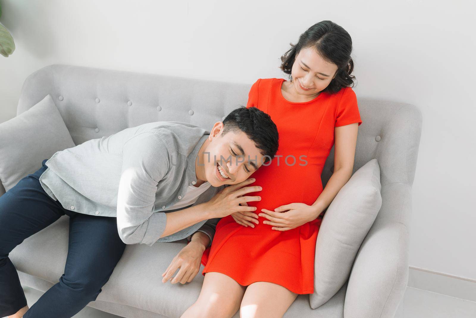 young pregnant woman with her husband expecting the baby