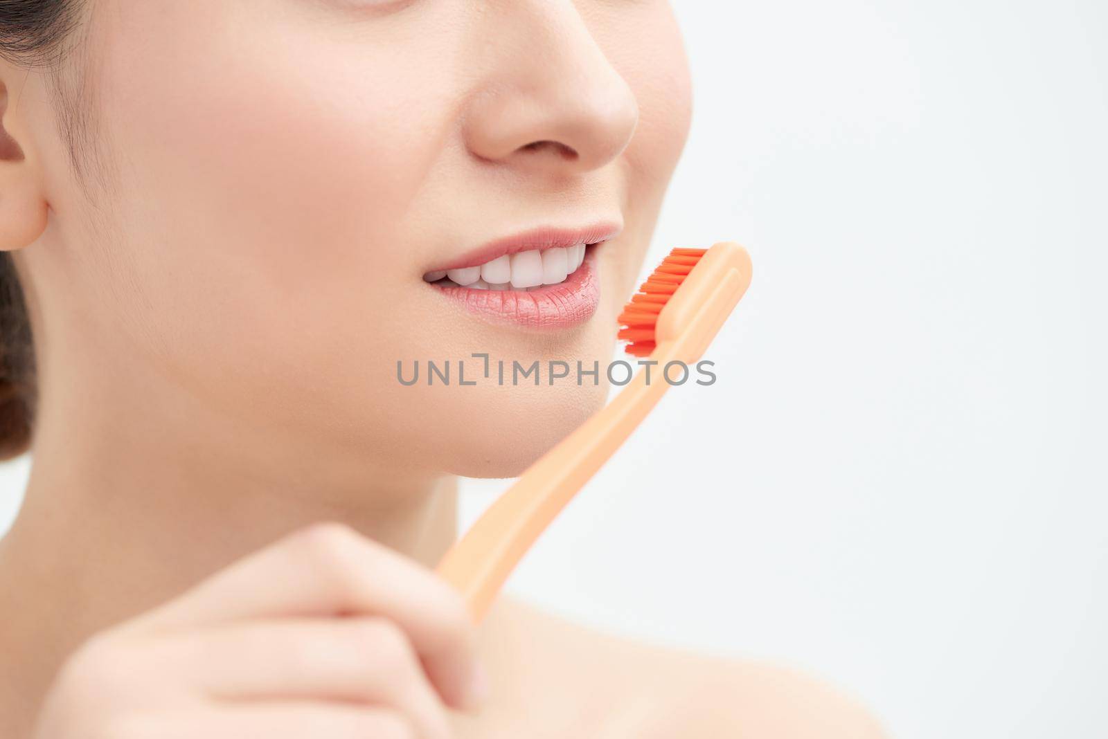 A asian woman cleans to a shine teeth