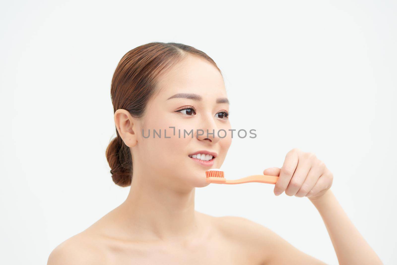 Young woman at home brushing teeth in the morning by makidotvn
