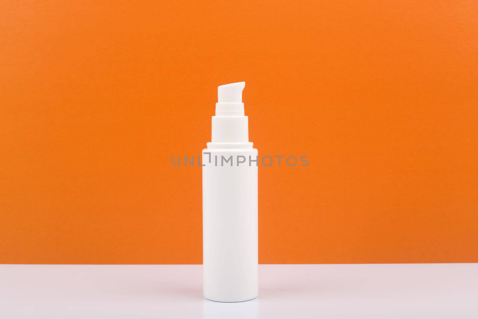 Face, neck or hands cream against orange background with copy space by Senorina_Irina