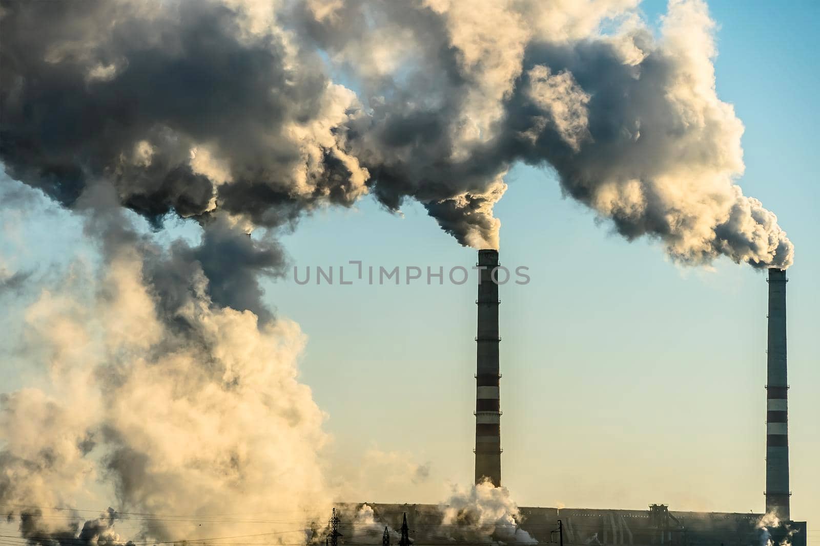 Smoking factory chimneys with co2 emissions.Environmental problem of environmental and air pollution.Climate change,ecology, global warming.The sky is smoky with toxic substances.Soot from factories by YevgeniySam